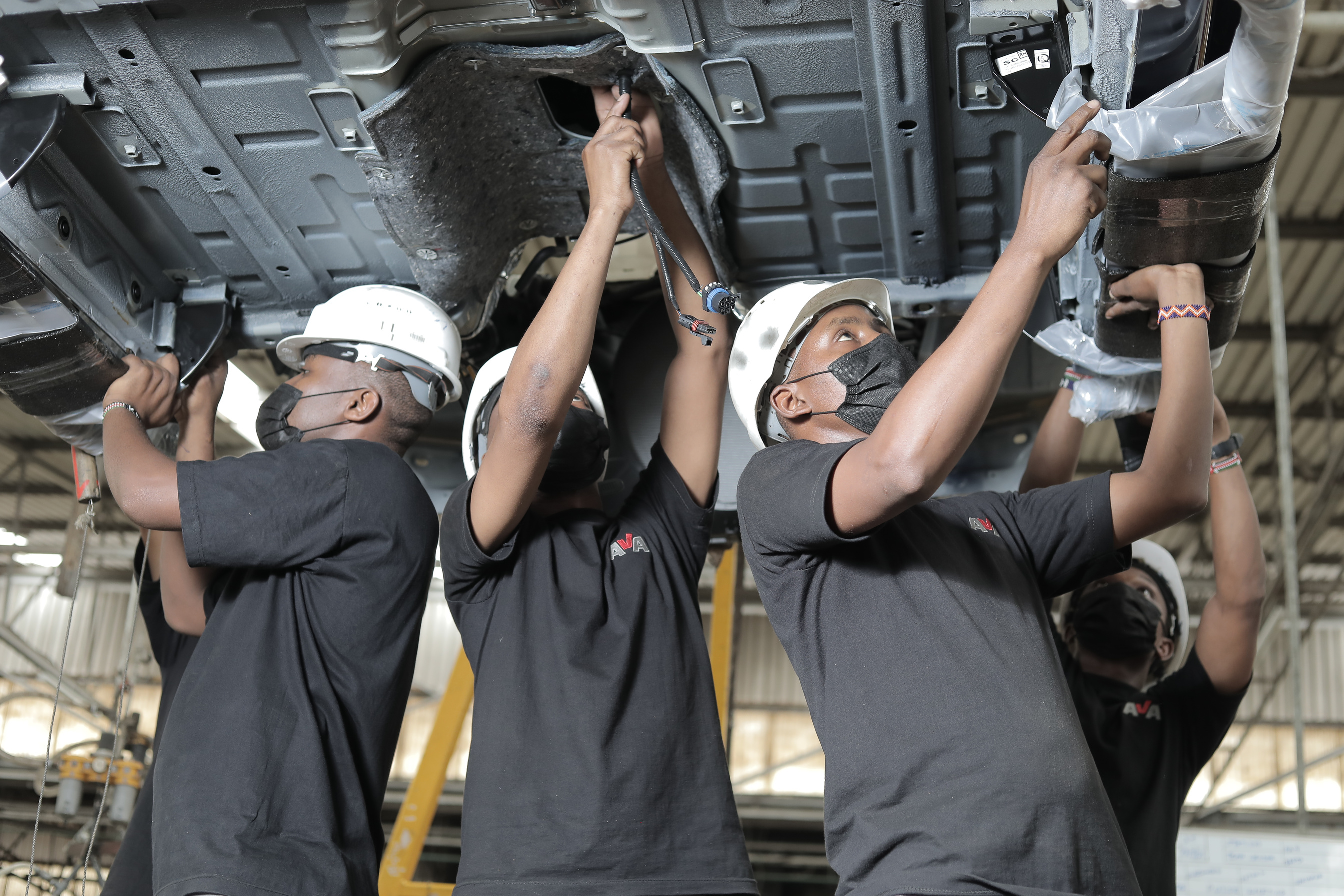 Auto Mechanics assembling a Car 